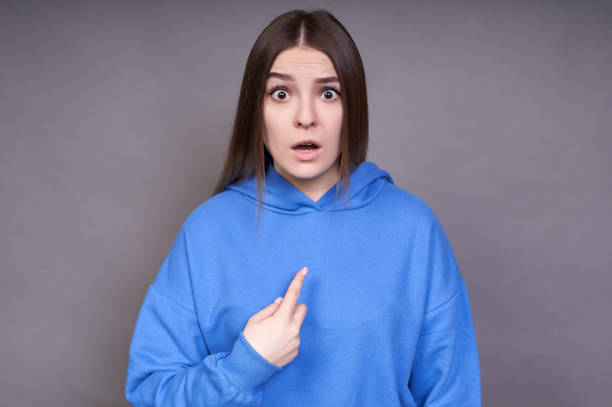 istock Dissatisfied, surprised woman points at herself indignantly. 1312424863