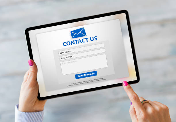 istock Person writing inquiry on contact form online 1312425704