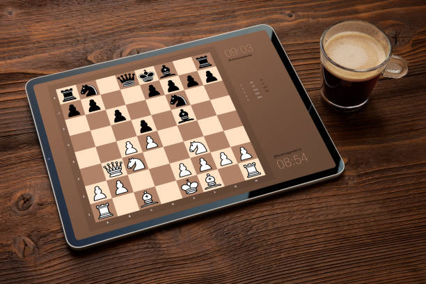 Digital tablet with chess app on screen Digital tablet with chess app on screen on dark background computer chess stock pictures, royalty-free photos & images