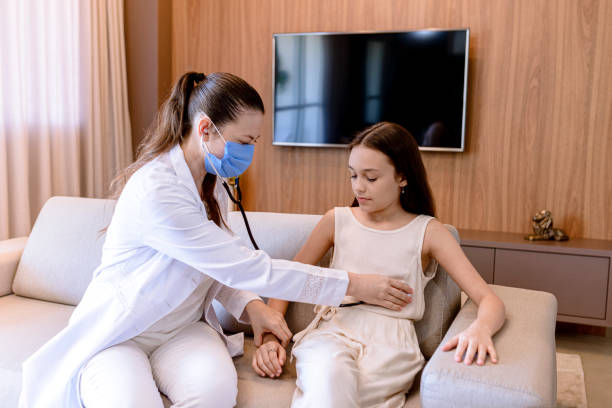 istock Young pediatric doctor performing home care. 1312426218