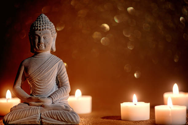 istock little buddha statue surrounded by tea candles 1312426426
