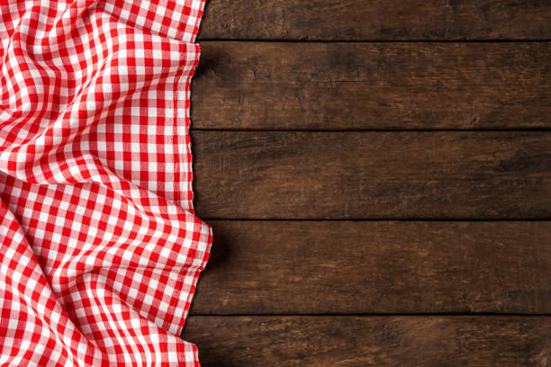 istock Red checkered tablecloth on wooden background 1312427404