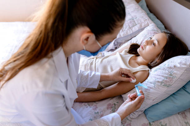 istock Young nurse applying vaccination at home 1312427801