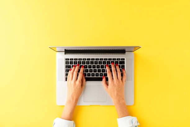 istock Woman’s hands working on laptop. Modern office desktop with copyspace. Top view 1312428427