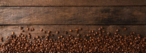 istock Coffee beans on wooden background with copyspace. 1312428459