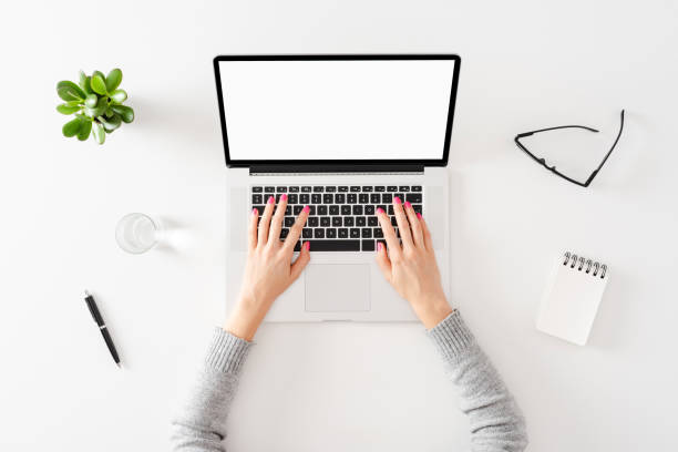 istock Woman using laptop. Office desktop with accessories 1312428529