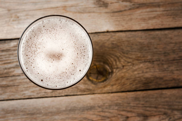 istock Beer glass on wooden table. Close up 1312428586