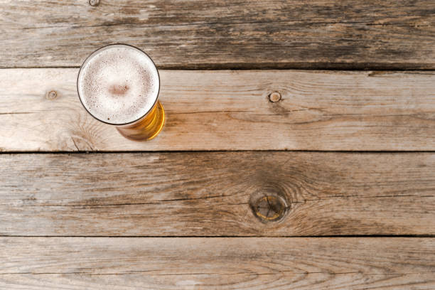 istock Beer glass on wooden table. Close up 1312428664