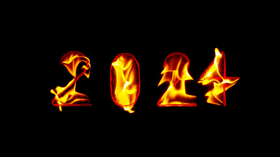 Close-up of fire inscription of year 2024 against black background.