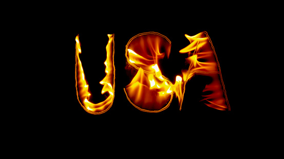 Close-up of fire inscription of word 'USA' burning against black background.