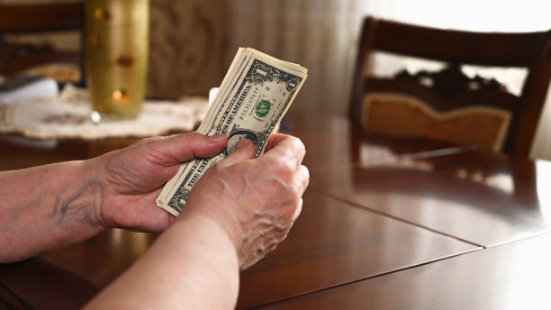 istock Close up of woman's hands counting US dollar bills. Saving concept 1312429177