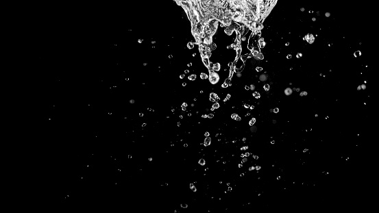 Close-up of water splashing against black background.