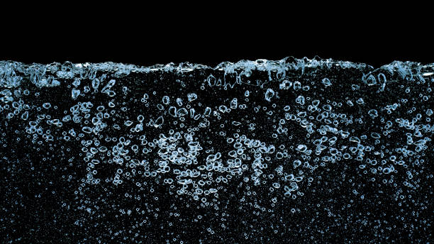 Close-up of air bubbles on water surface Close-up of air bubbles on water surface against black background. water on black surface stock pictures, royalty-free photos & images