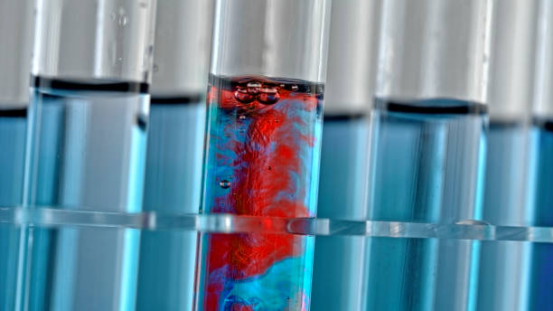Close-up of test tube with blue liquid changing to red colour during chemical reaction.