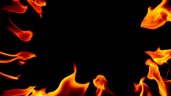 Close-up of flame against black background.