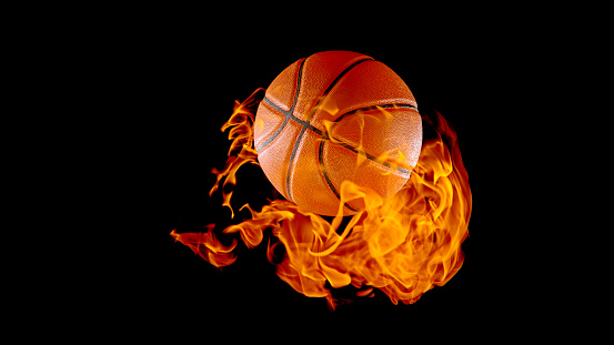 Close-up of burning basketball against black background.