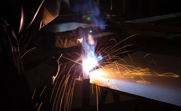 istock A man welder with construction gloves and a welding mask is welded with a welding machine metal in workshop. 1312431903