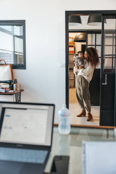 istock Young mother in the office with her baby 1312434657