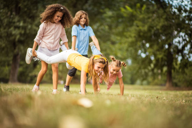 istock Fun time.  Group of school kids having fun in nature. 1312436353