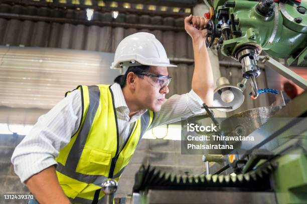 Asian Mechanical Engineer Checking Equipment In Factory Factory Workers Using Machine Equipment In Workshop Asian Mechanical Engineer Operating Industrial Lathe Machine Stock Photo - Download Image Now