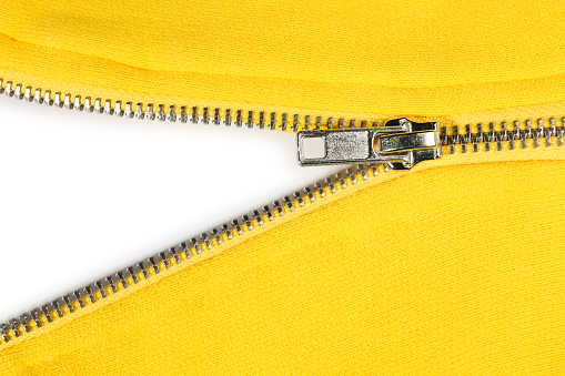 Yellow sweatshirt with zipper as background, top view