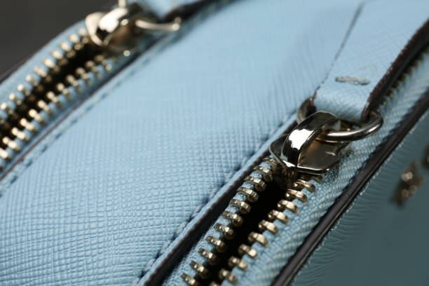 istock Light blue women's bag with zippers, closeup view 1312440600