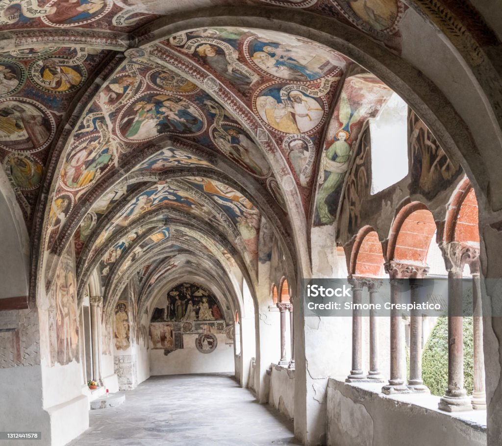 Cloister with fresco paintings of the Cathedral Duomo Santa Maria Assunta (German: Dom Mariae Aufnahme in den Himmel und St. Kassian) of Bressanone - Brixen. Trentino Alto Adige South Tyrol, Südtirol, Italy. Ancient Stock Photo