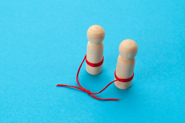 istock Significant other. The figures of people are connected with a thread. The problem is in the relationship, communication in a couple 1312441900