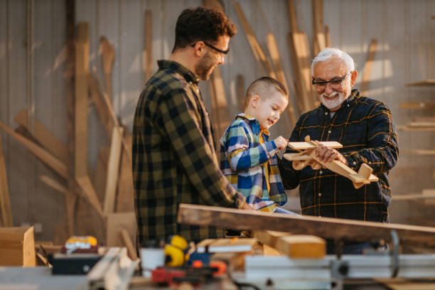 istock Three generation of family playing in carpenter workshop 1312442739