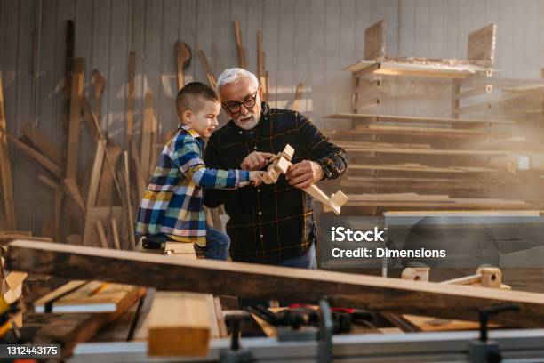 Grandfather Made A Wooden Plane For His Grandson Stock Photo - Download Image Now - Grandfather, Child, Grandson