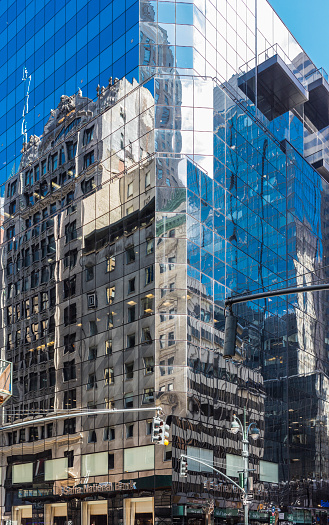 New York City, United States - August 25, 2008: The glass windows of the Safra National Bank building reflect the facades of other buildings (Fifth Avenue, Midtown Manhattan).