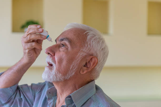 istock A Senior Man with Cataract or Conjunctivitis is Using an Eye Drops at Home. 1312444041