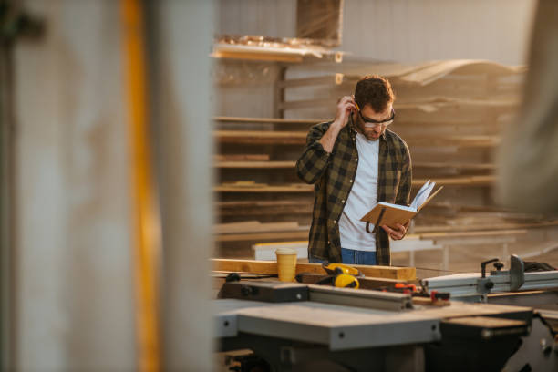 istock Handsome carpenter working in the shop 1312444526