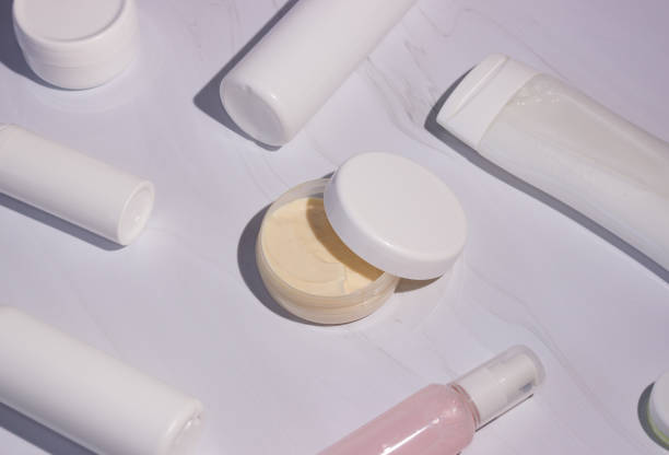 istock Cream in a jar with an open lid and bottles for cosmetics. shadows 1312445980