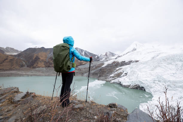 istock Successful woman backpacker hiking in winter mountains 1312446142