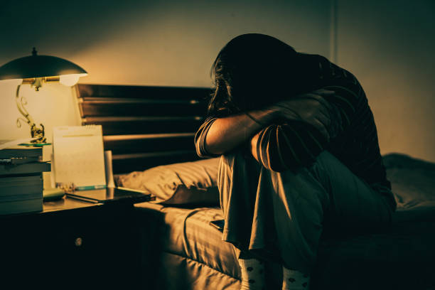 istock Sad Woman Sitting On Bed At Home 1312446983