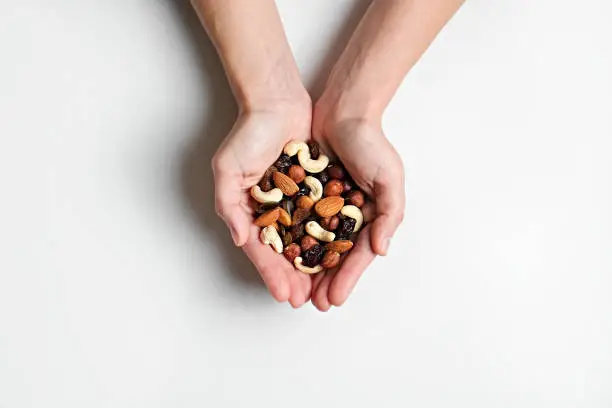 Photo of Bunch of different nuts on white table.