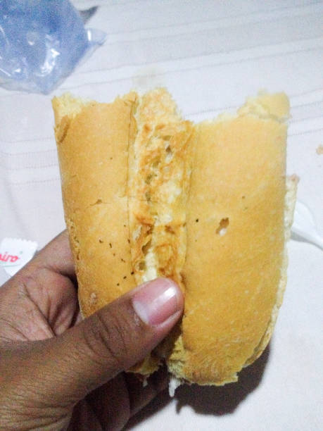 istock Half French bread with one hand 1312447610