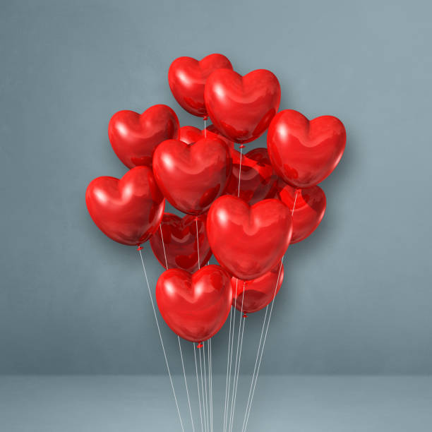 istock Red heart shape balloons bunch on a grey wall background 1312447639