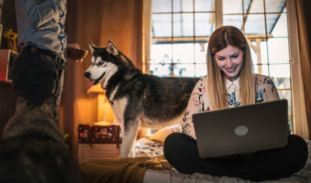istock a young couple spends time at home with a dog 1312448772