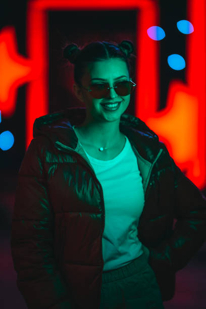 istock Modern woman on the streets and neon light 1312448867