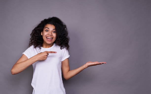 istock Surprised young dark-skinned lady points his finger . 1312449830
