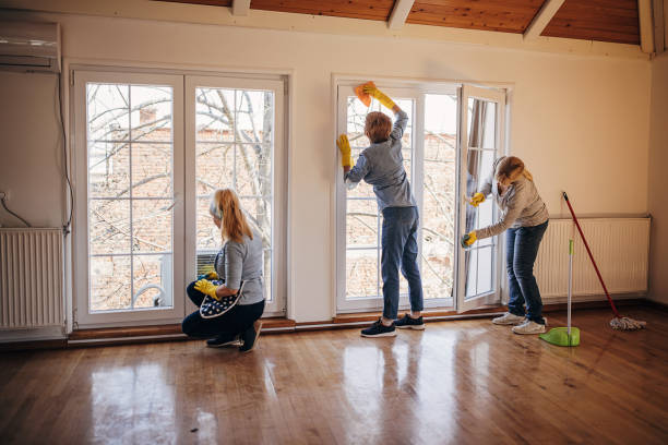 Women cleaning windows in apartment Three women, mature women cleaners from cleaning service, washing windows in apartment together. housekeeping staff photos stock pictures, royalty-free photos & images