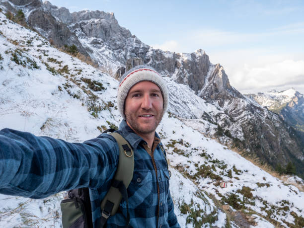 istock Hiker male takes selfie on mountain trail 1312455316