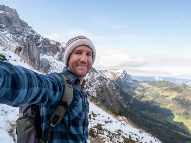 istock Hiker male takes selfie on mountain trail 1312455369