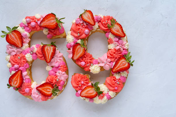istock Birthday cake. Unusual modern design with strawberries. Spring time. Postcard for the holiday. Congratulations are bright and creative. Beautiful cake in the shape of number 69 1312456295