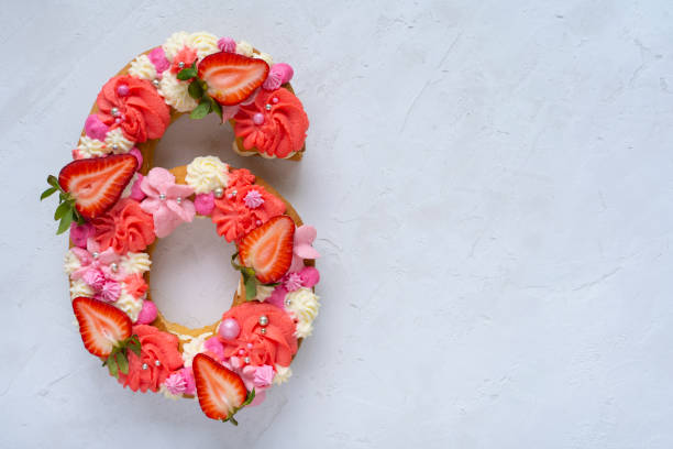 istock Birthday cake. Unusual modern design with strawberries. Spring time. Postcard for the holiday. Congratulations are bright and creative. Beautiful cake in the shape of number 6 1312456298