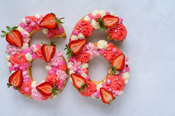 istock Birthday cake. Unusual modern design with strawberries. Spring time. Postcard for the holiday. Congratulations are bright and creative. Beautiful cake in the shape of number 66 1312456302