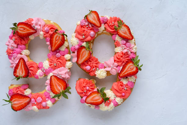 istock Birthday cake. Unusual modern design with strawberries. Spring time. Postcard for the holiday. Congratulations are bright and creative. Beautiful cake in the shape of number 99 1312456304