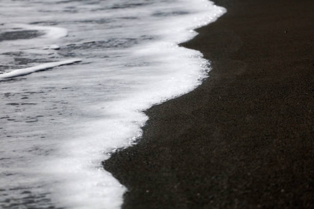 istock soft waves with white foam come ashore at sunset 1312456431